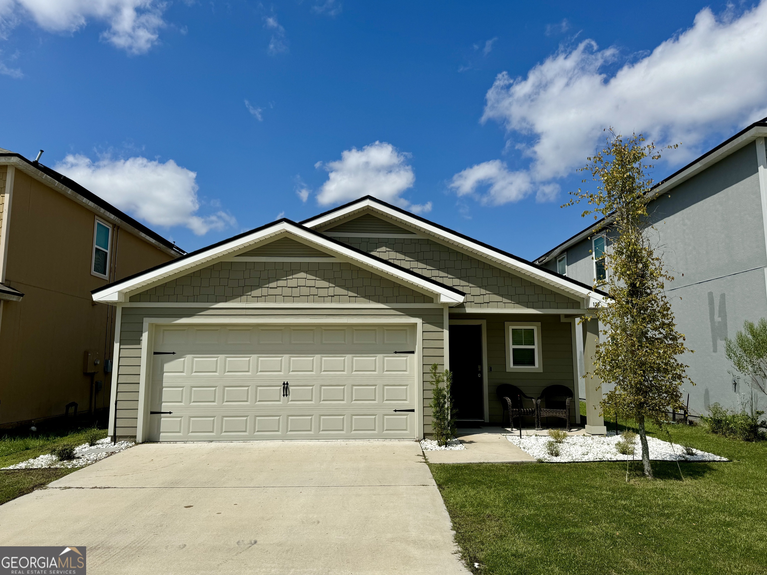 a front view of a house with a yard and garage