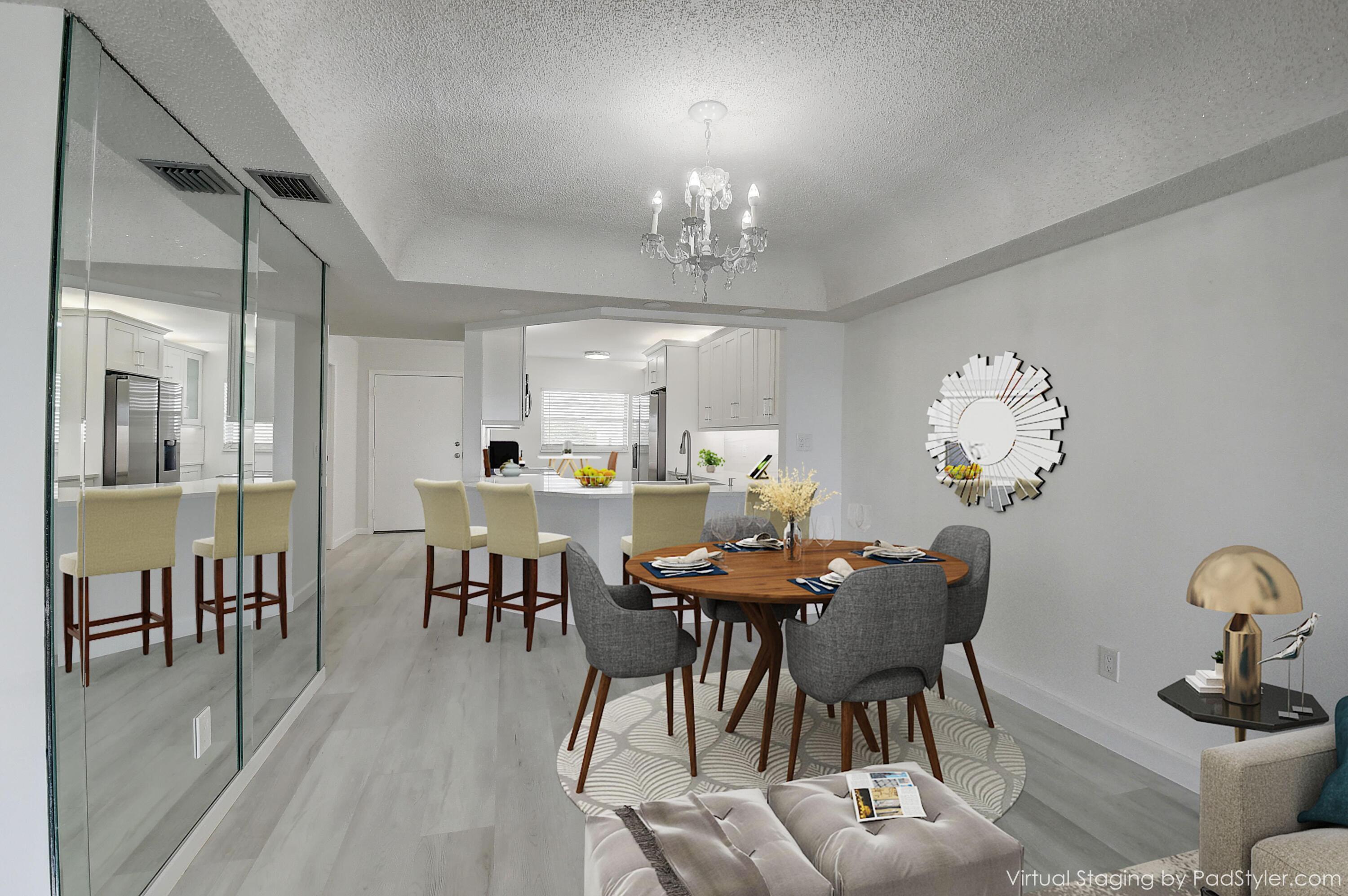 a view of a dining room with furniture and chandelier