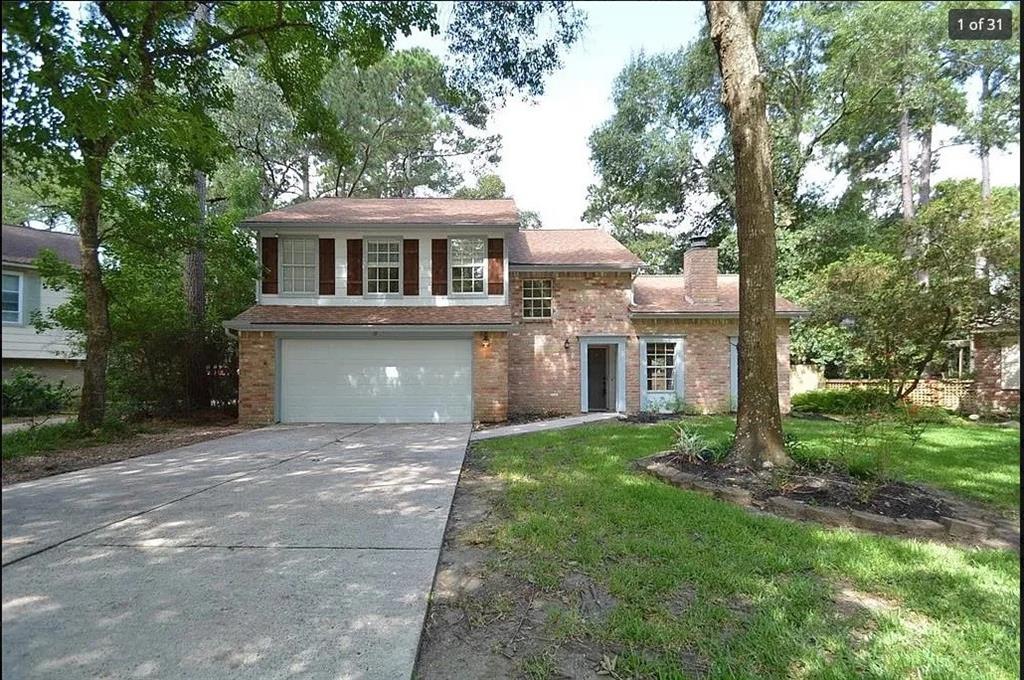 a front view of house with yard and trees