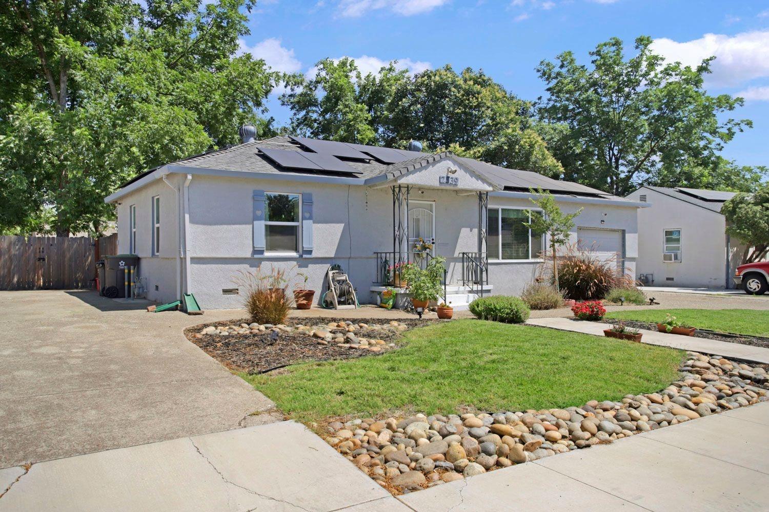 a front view of house with yard and green space