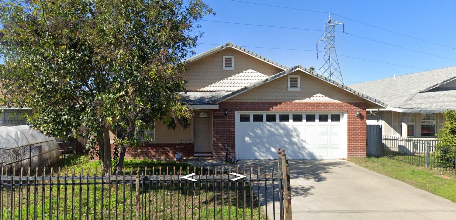 a front view of house with a garden