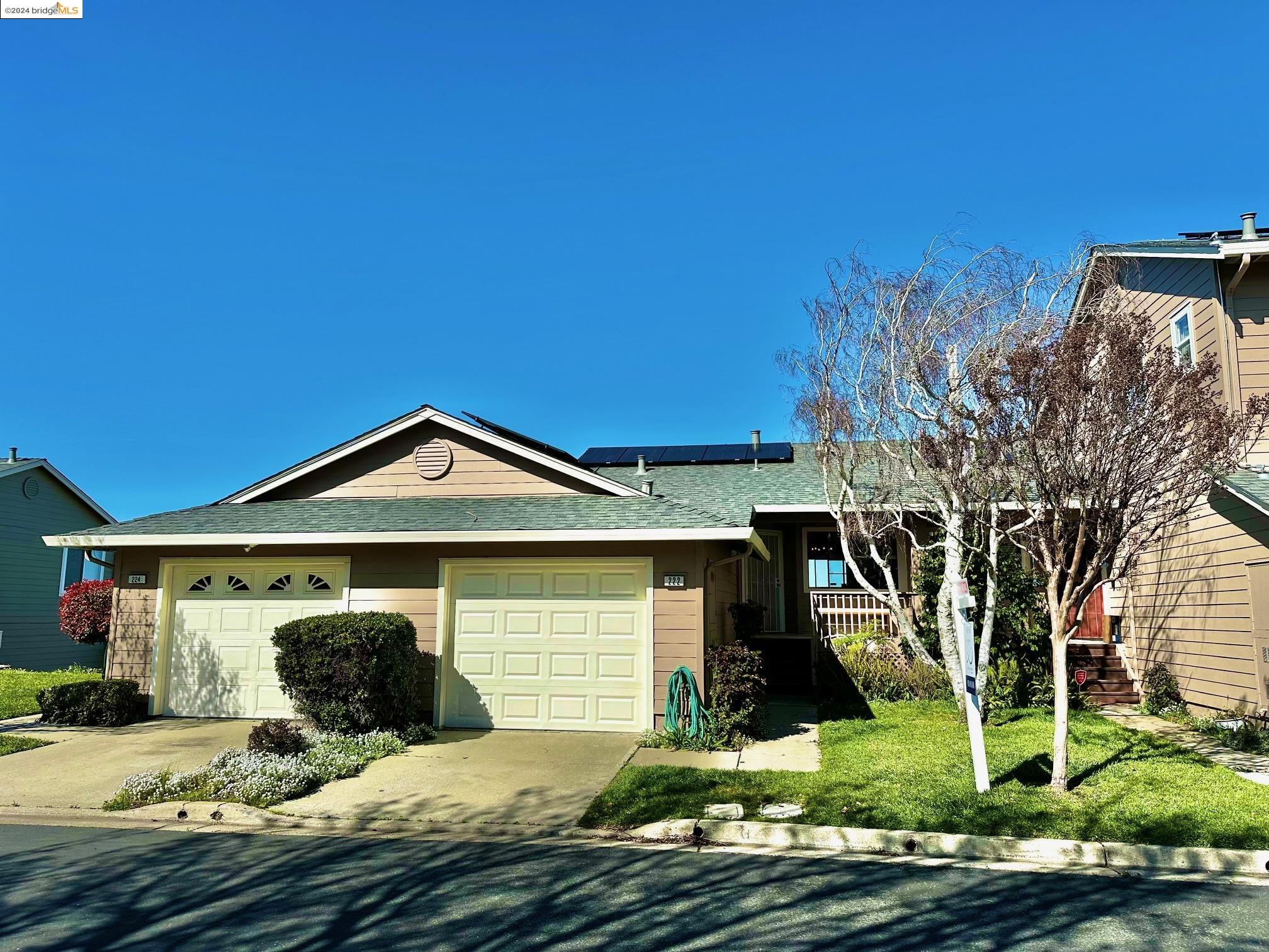 a front view of a house with garden