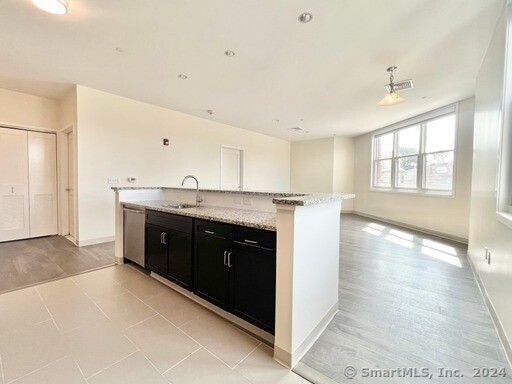 a spacious bathroom with a granite countertop double vanity and a mirror