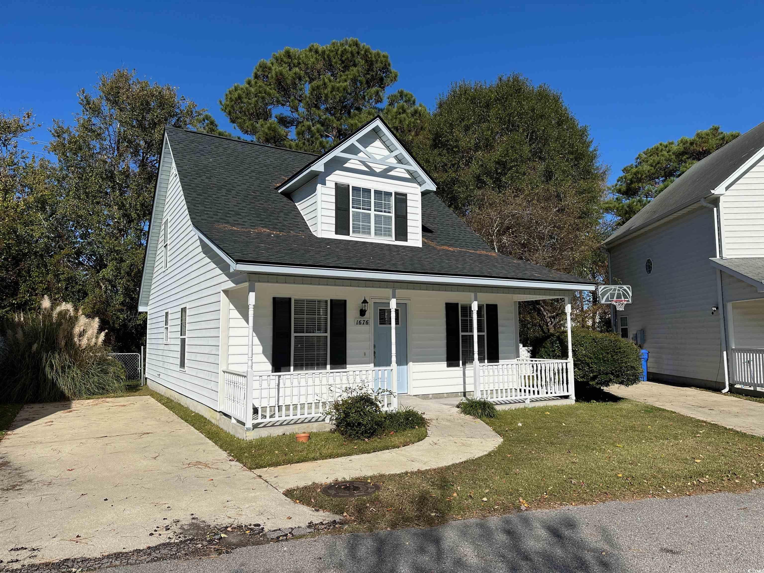 View of front of house featuring covered porch and