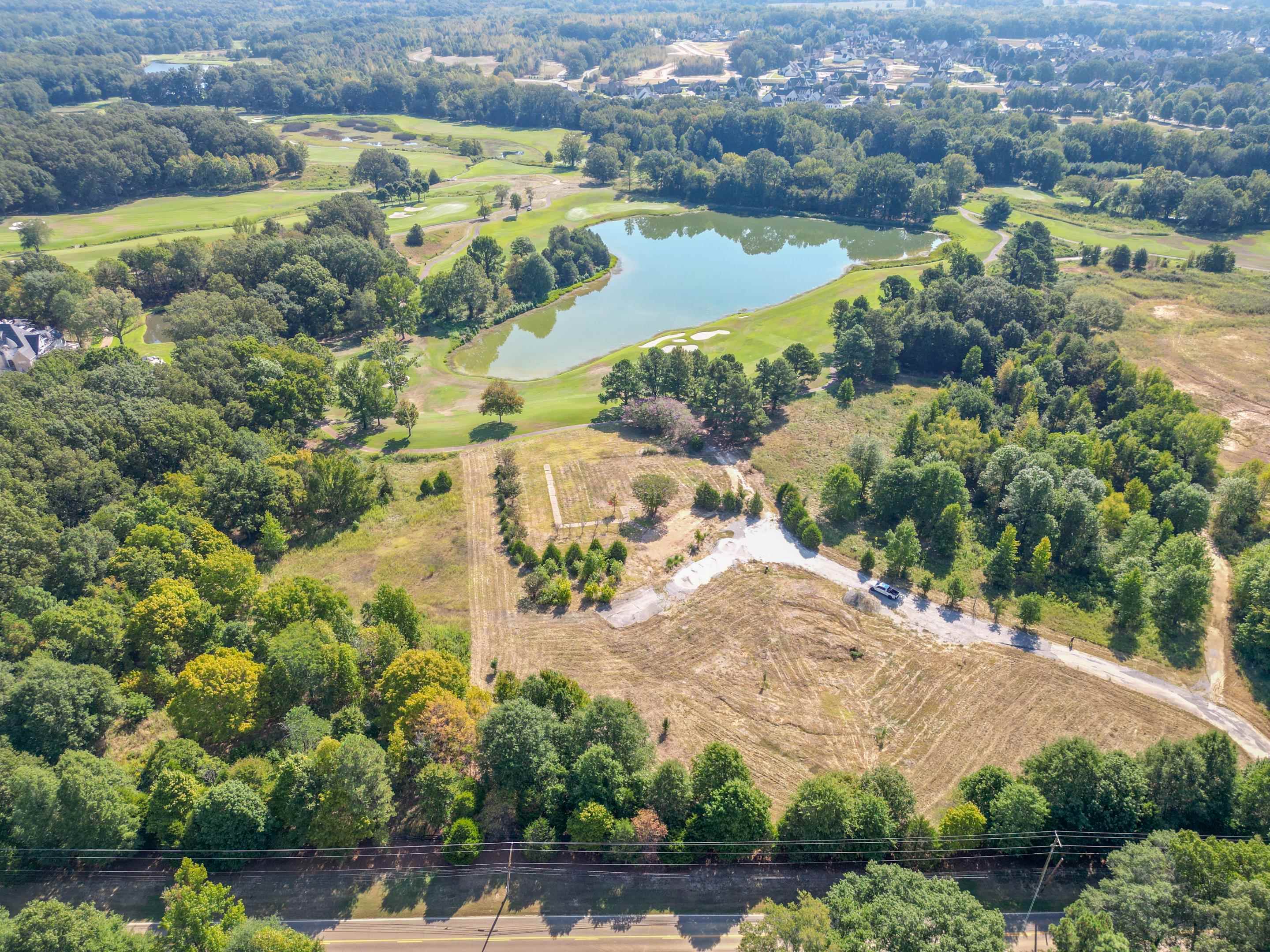 an aerial view of residential houses with outdoor space and swimming pool