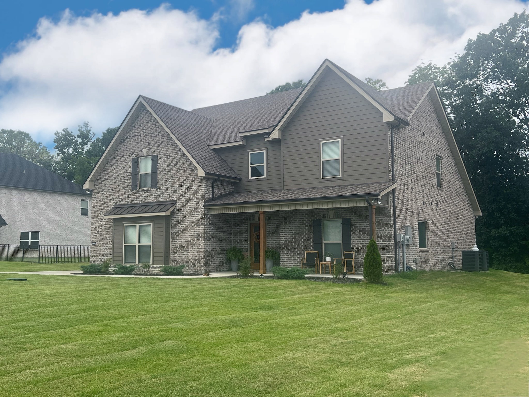 a front view of a house with a garden