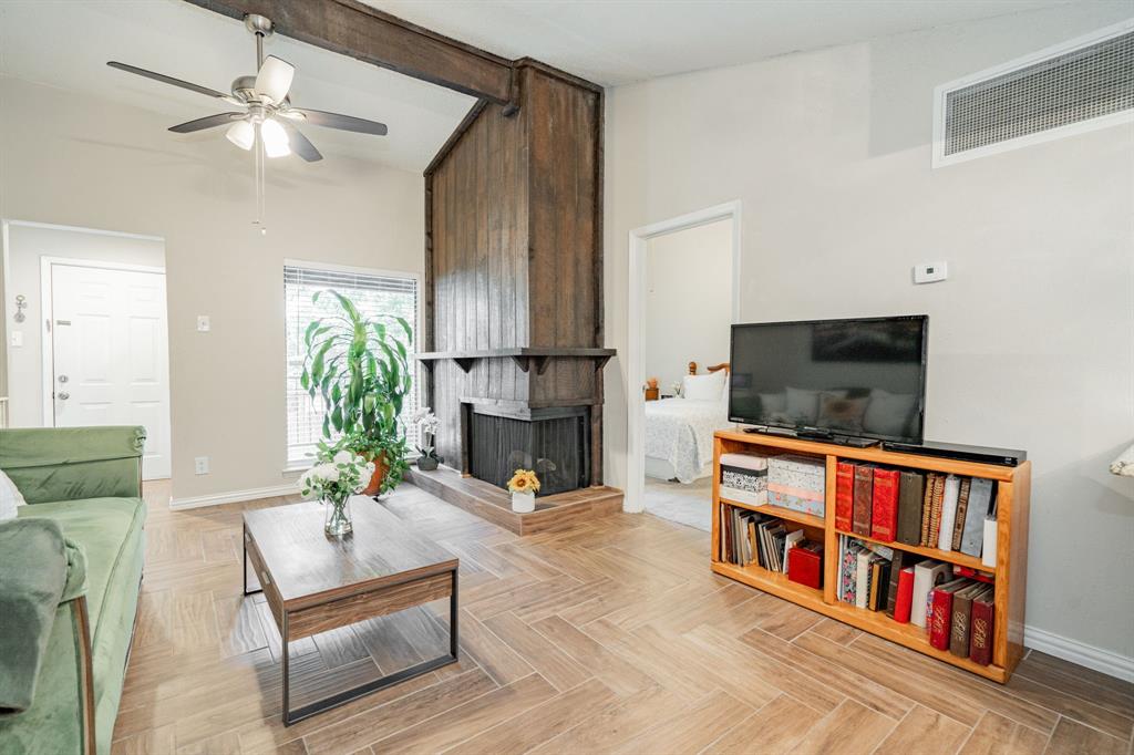 a living room with fireplace furniture and a flat screen tv