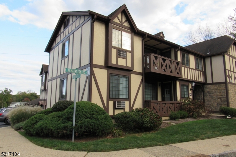 a front view of a house with plants and entryway