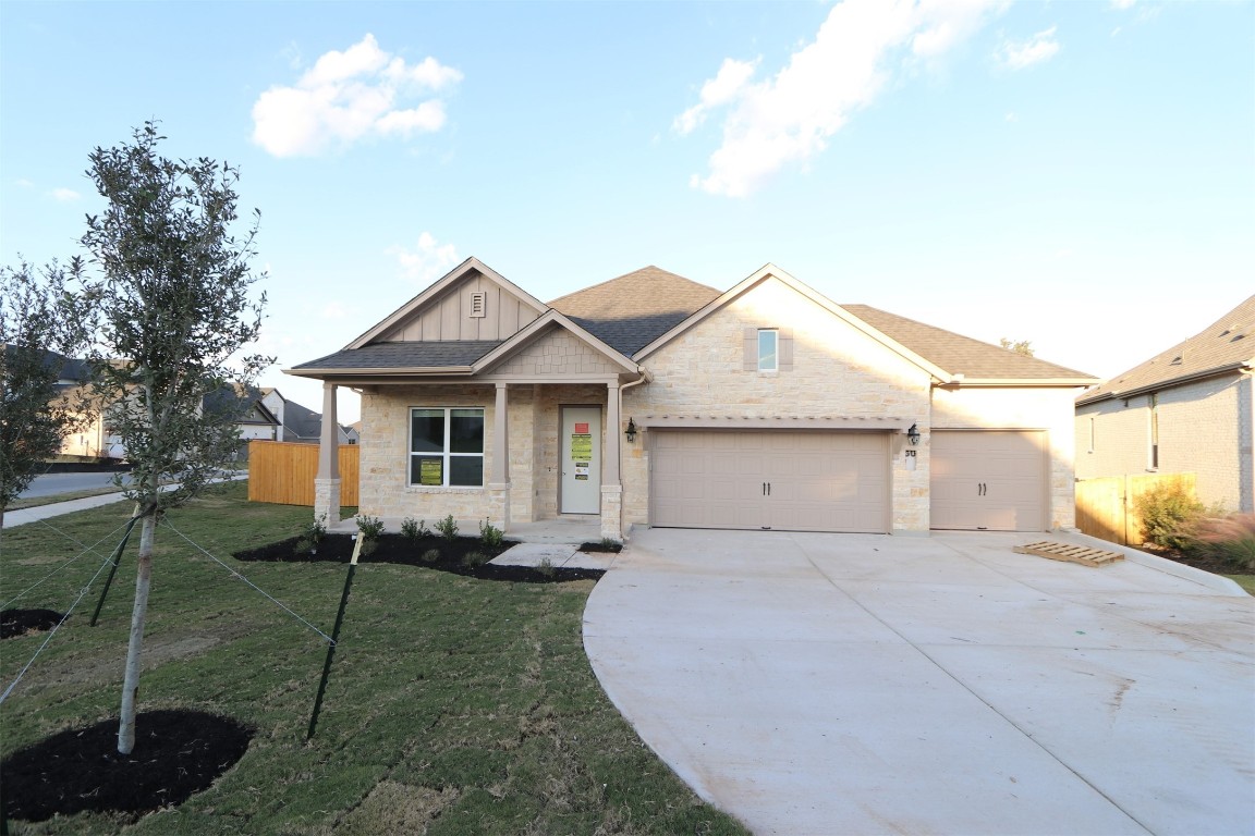 a front view of a house with a garden and plants