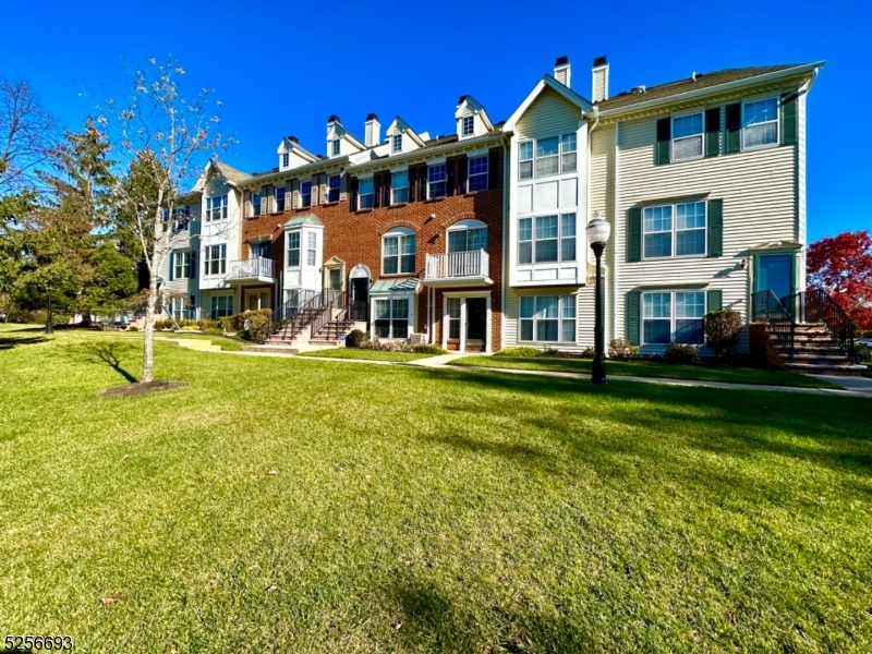 a front view of building with yard and green space