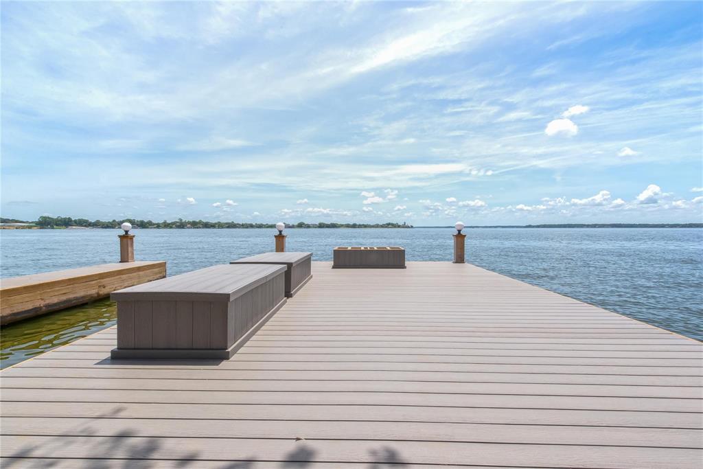 a view of a terrace with wooden floor and lake view