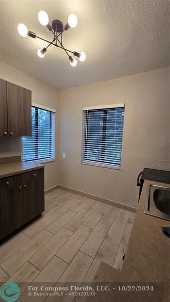 a kitchen with a sink a cabinets and window