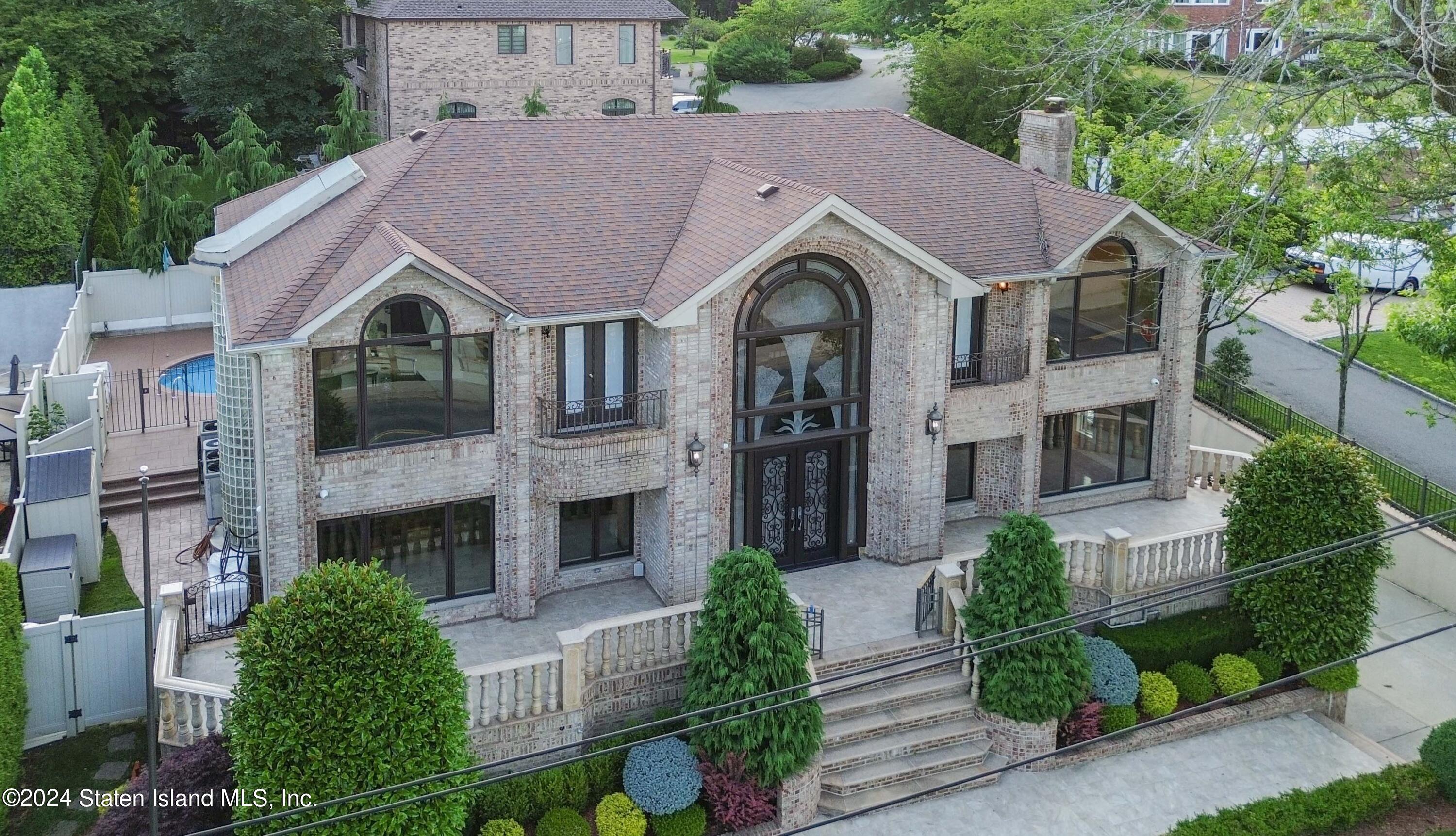 a aerial view of a brick house next to a yard