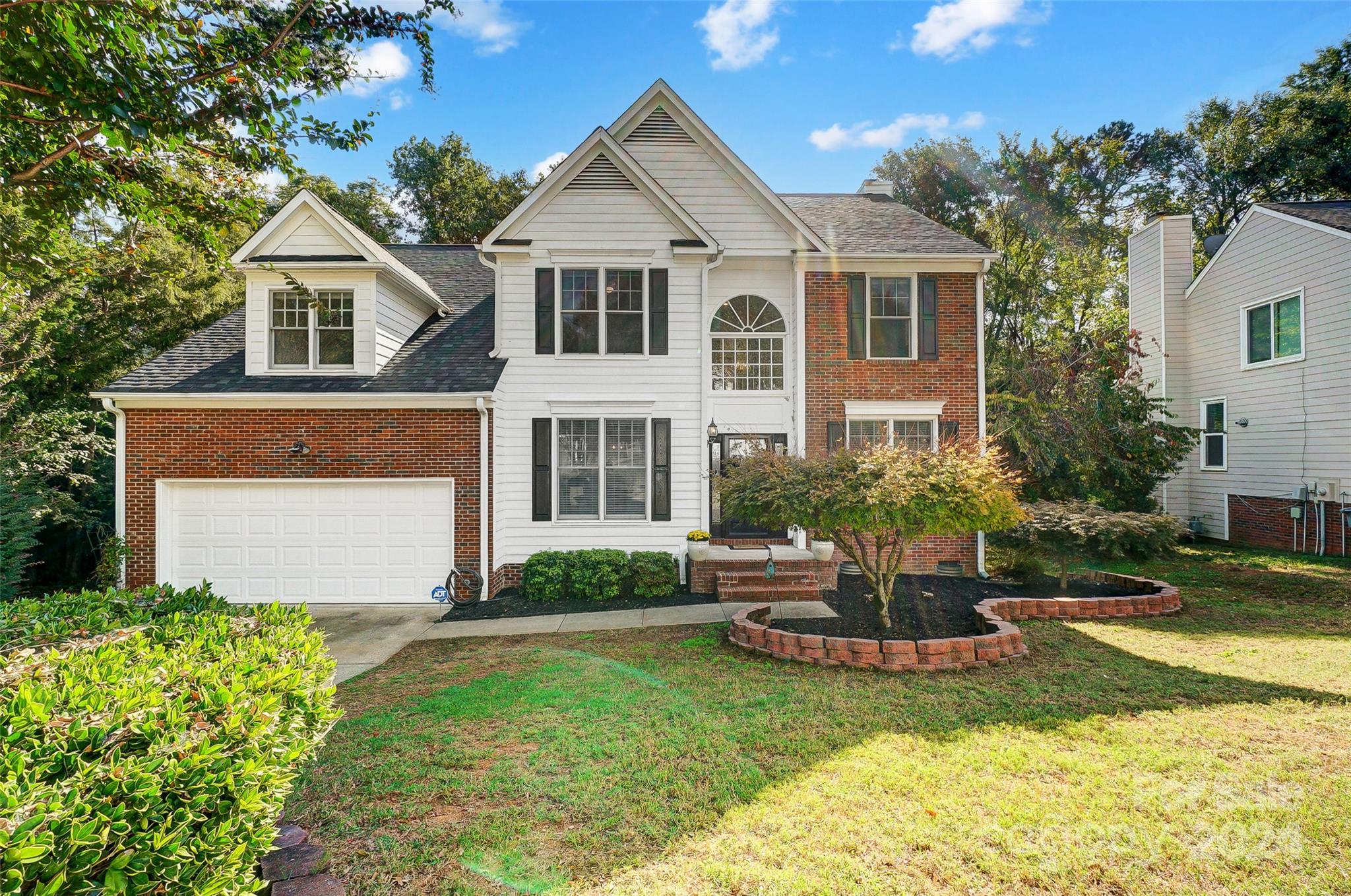 a front view of a house with a yard and porch