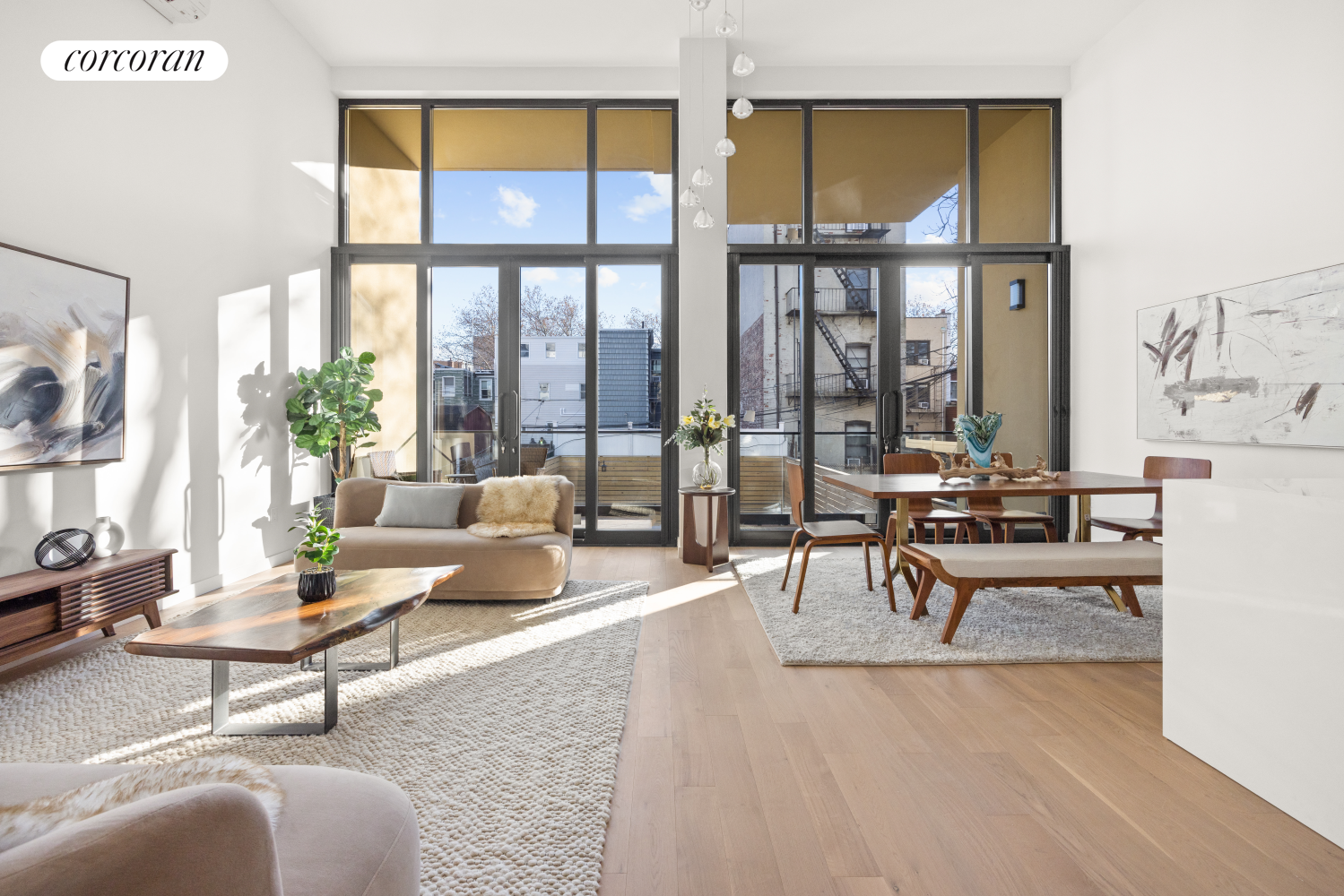 a living room with furniture and a floor to ceiling window