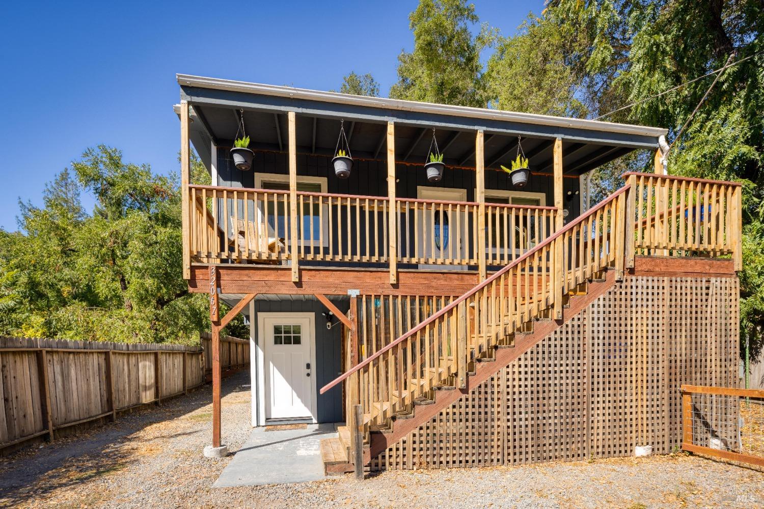 a view of a house with wooden fence