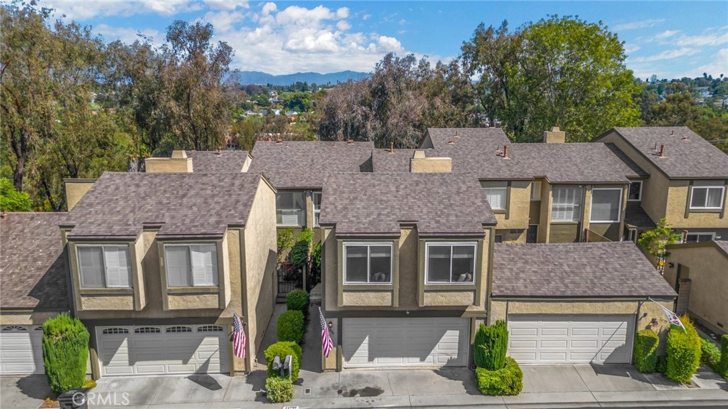 a aerial view of a brick house next to a yard