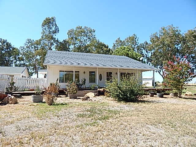 a front view of a house with a yard and seating space