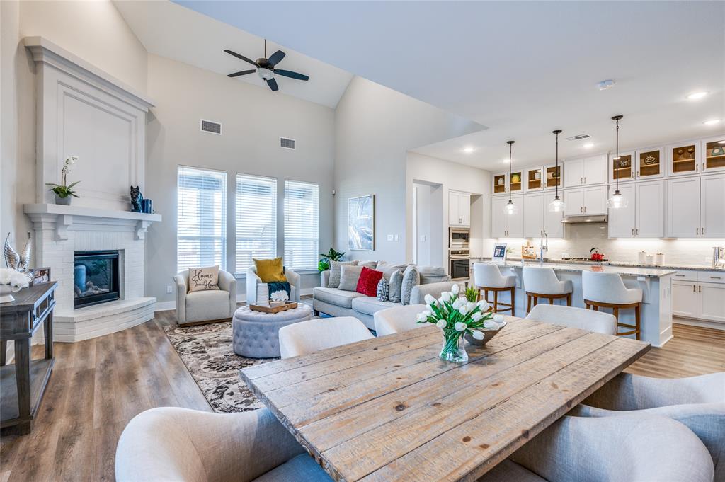 a living room with furniture fireplace and dining table