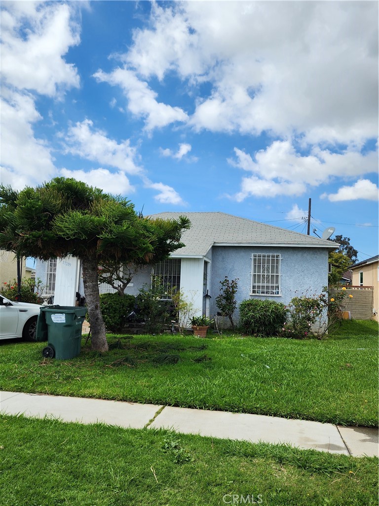 a front view of a house with a garden and yard