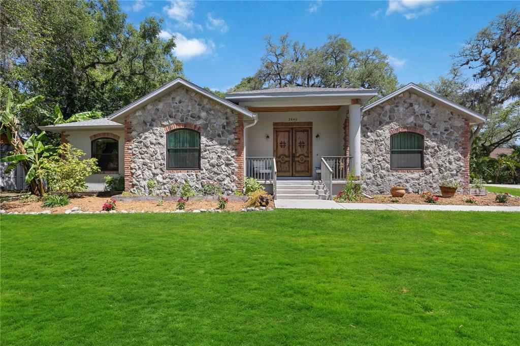 a front view of house with yard and green space