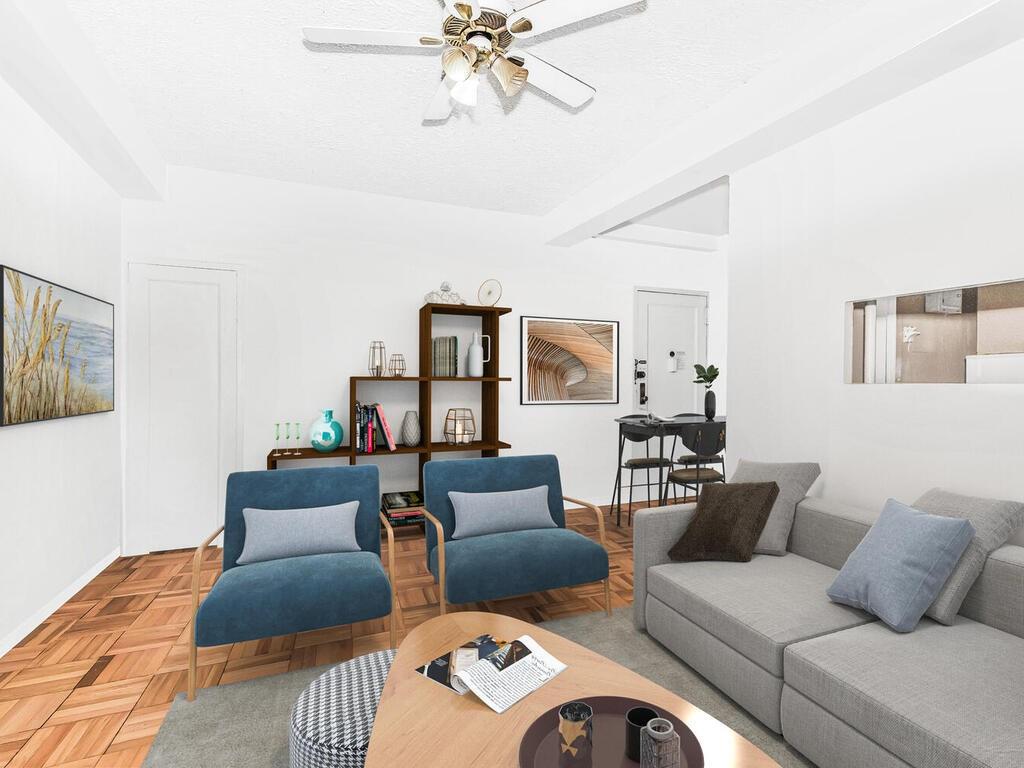 Living room with ceiling fan and light parquet flooring