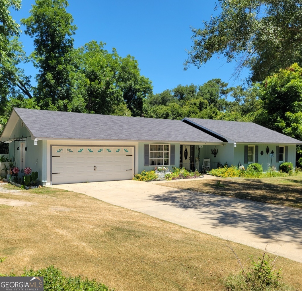 a front view of a house with a garden