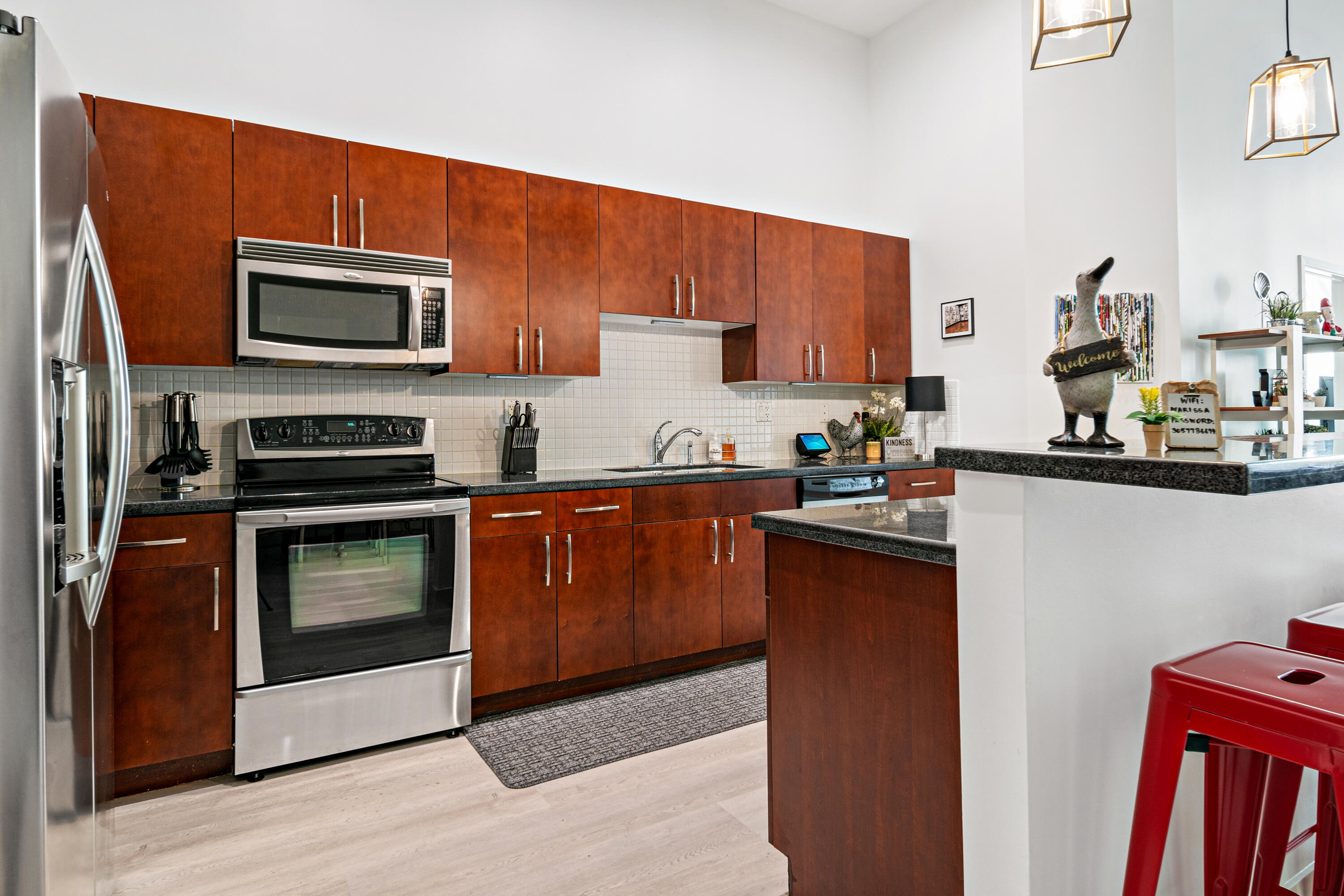 a kitchen with stainless steel appliances a stove a microwave a sink and cabinets