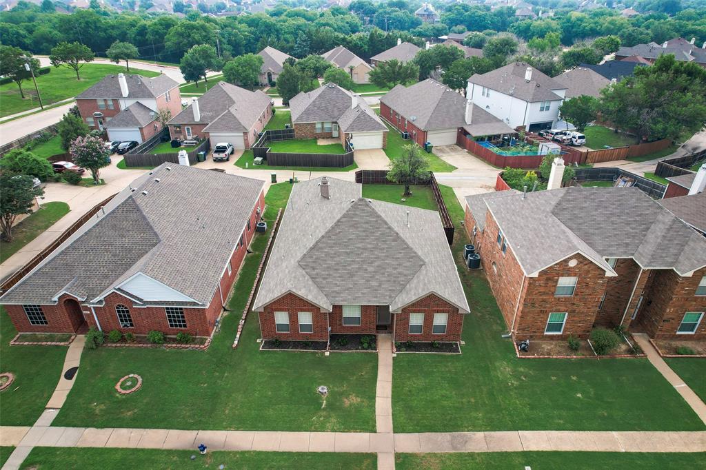 an aerial view of multiple houses with a yard