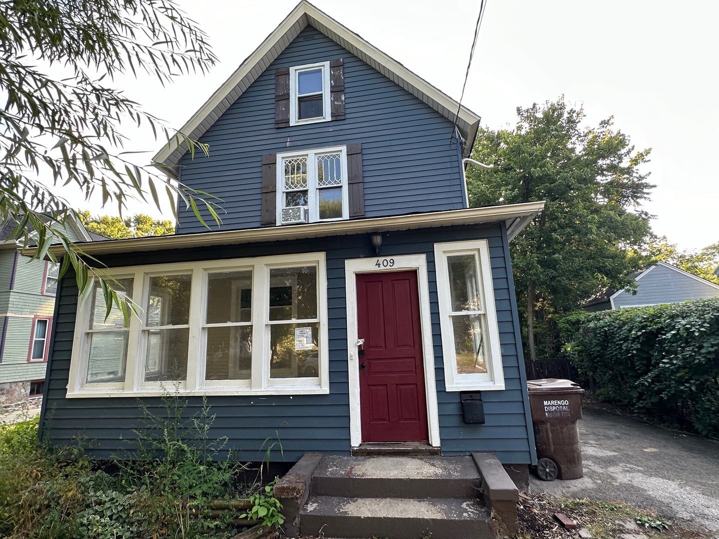 a front view of a house with a garden