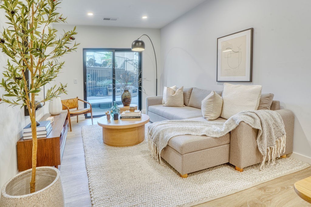 a living room with furniture and a potted plant