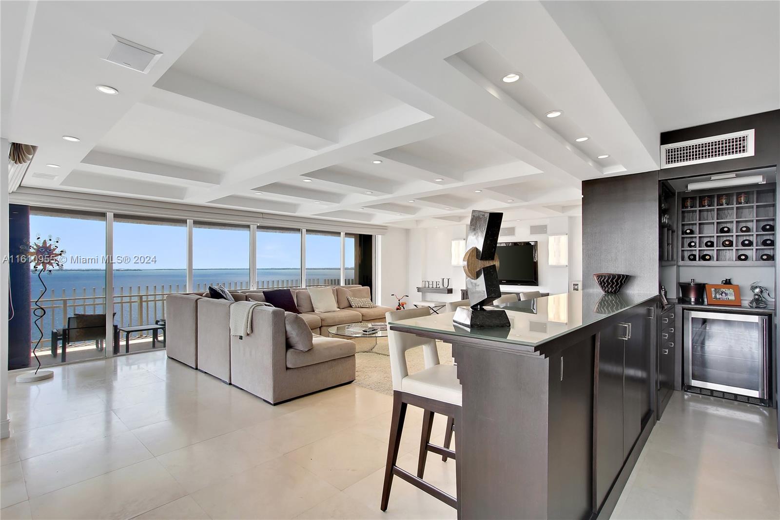 a kitchen with kitchen island a large counter top space a sink stainless steel appliances and cabinets