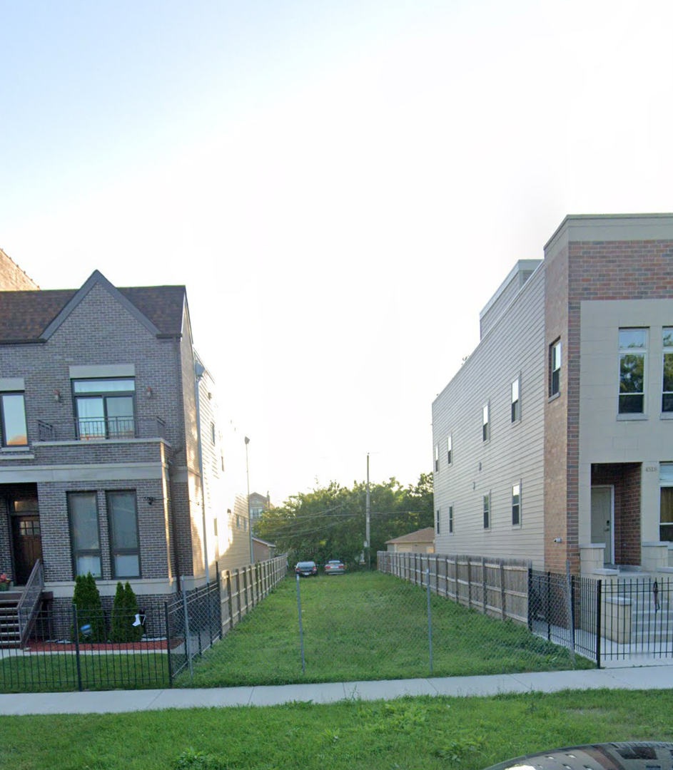 a view of a house with a big yard and large trees