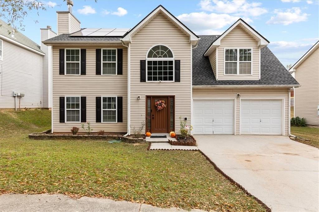 a front view of a house with a yard