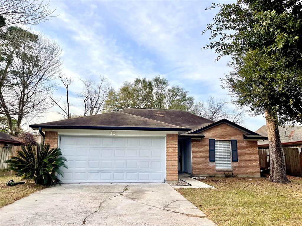 a view of a house with a yard and garage