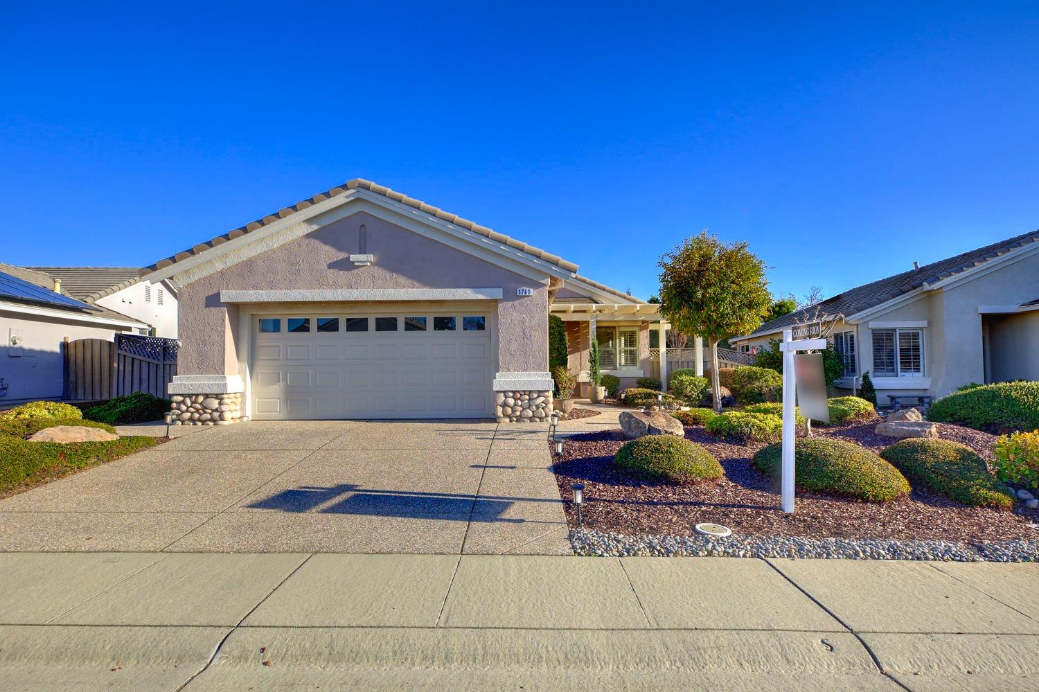 a front view of a house with garden