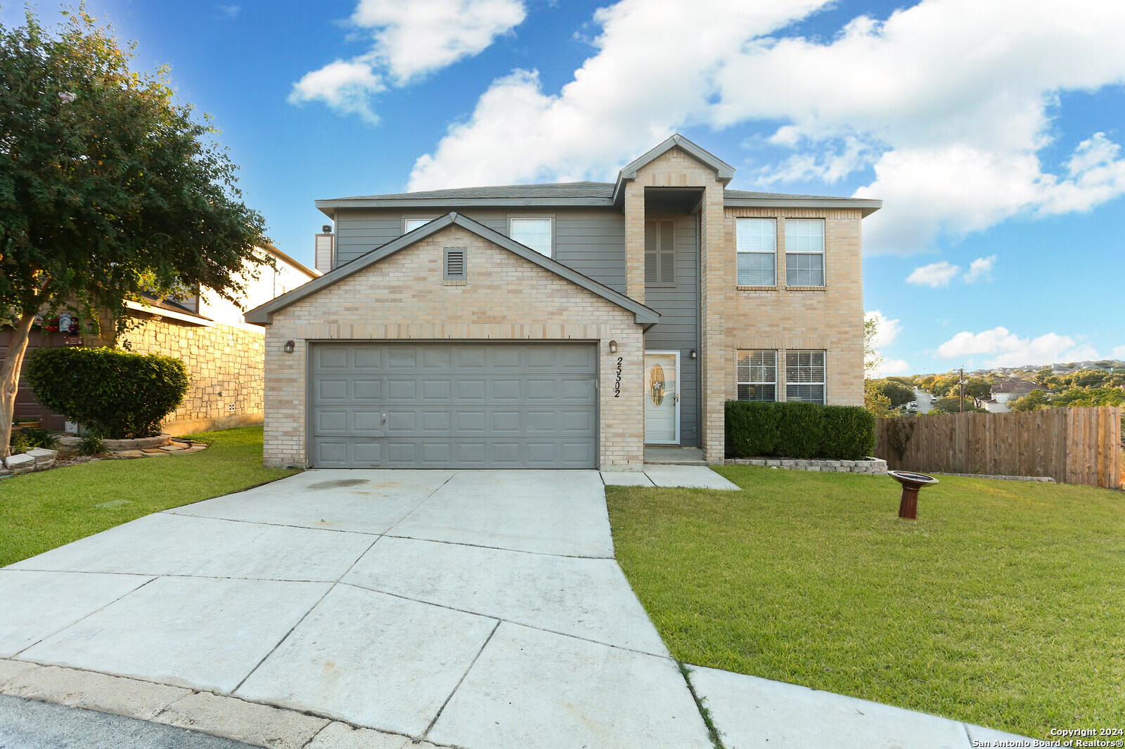 a front view of a house with a yard and garage