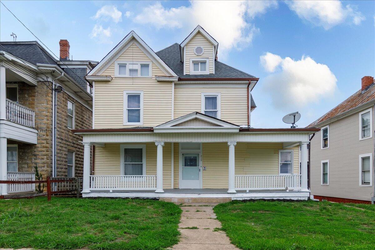 a front view of a house with a yard and porch