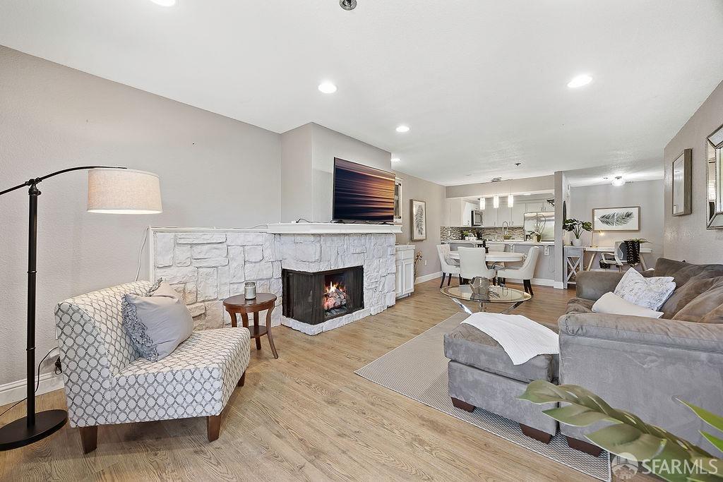 a living room with furniture a fireplace and a flat screen tv