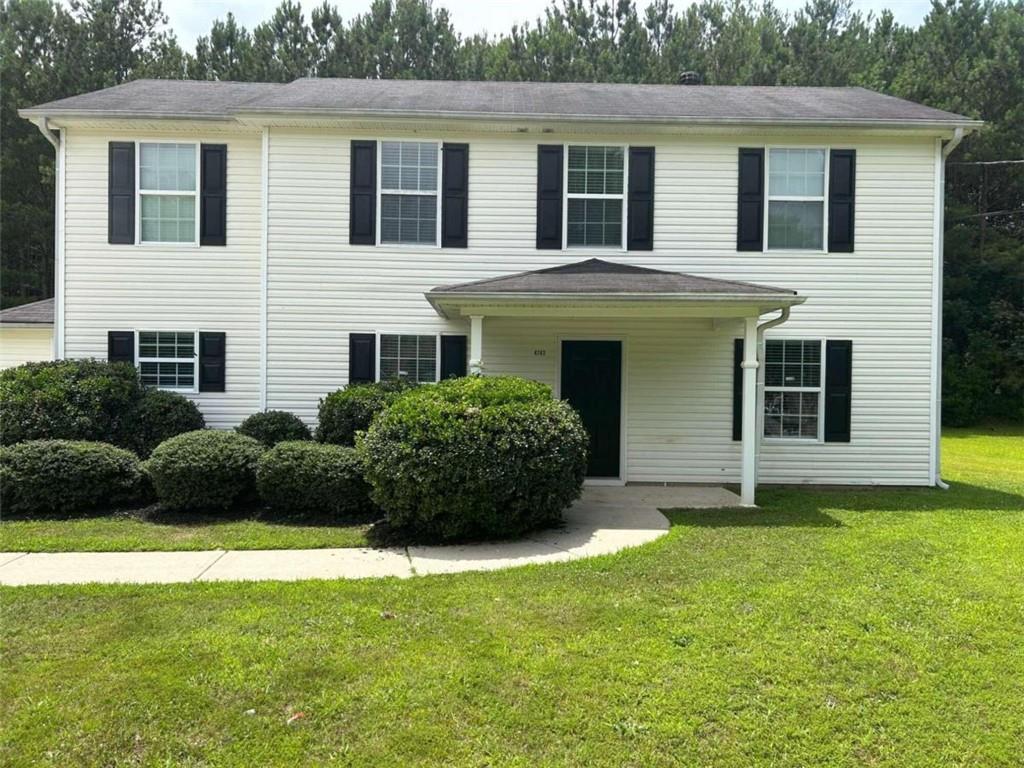 a view of a house with a yard