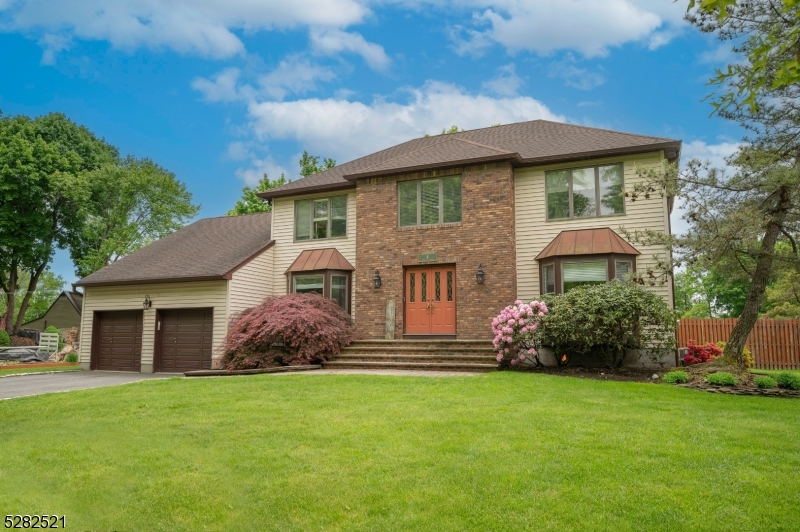 a front view of a house with a garden