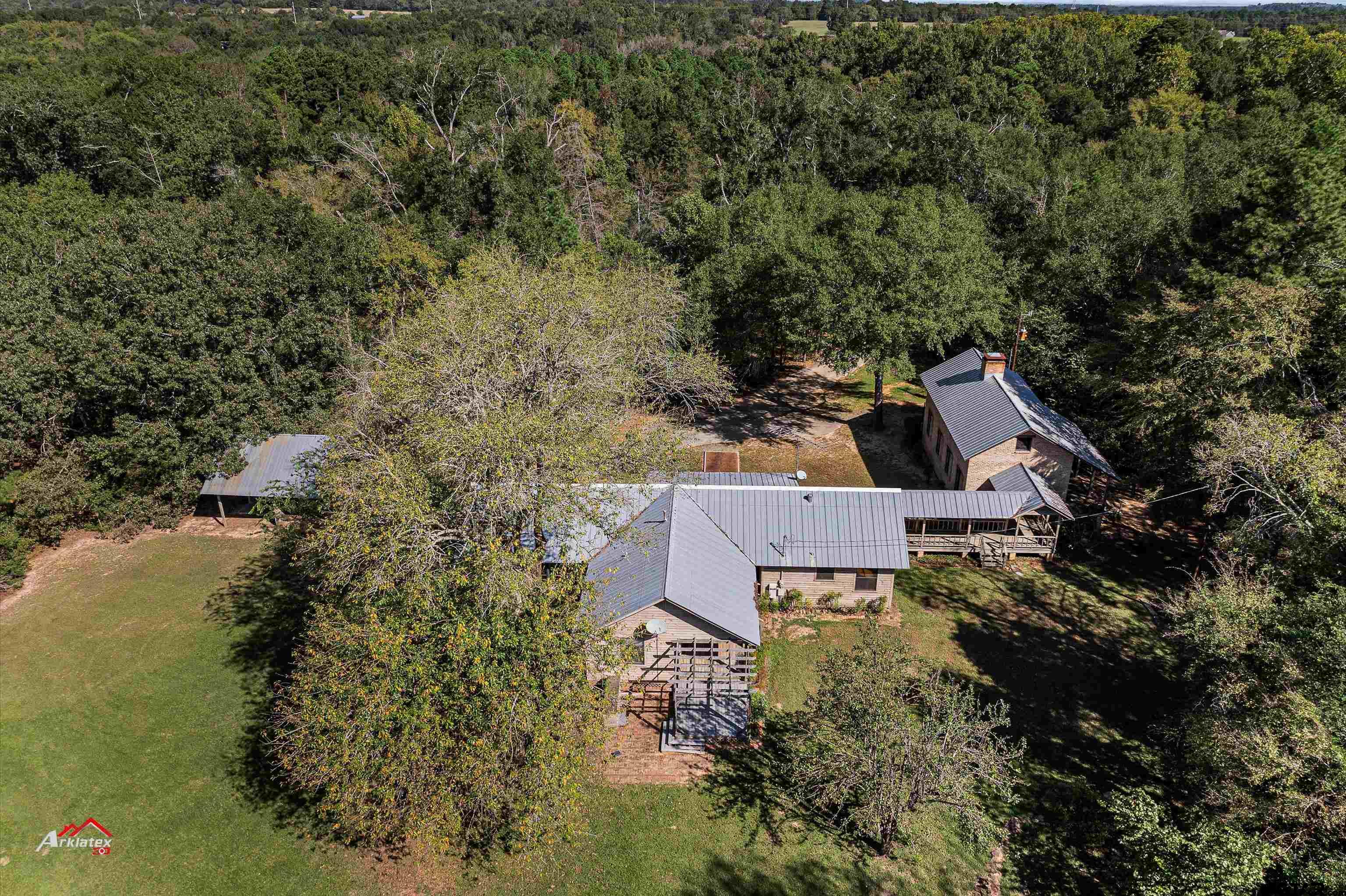 an aerial view of a house with a yard