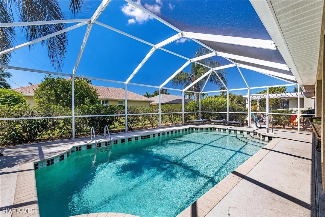 a view of a backyard with table and chairs under an umbrella