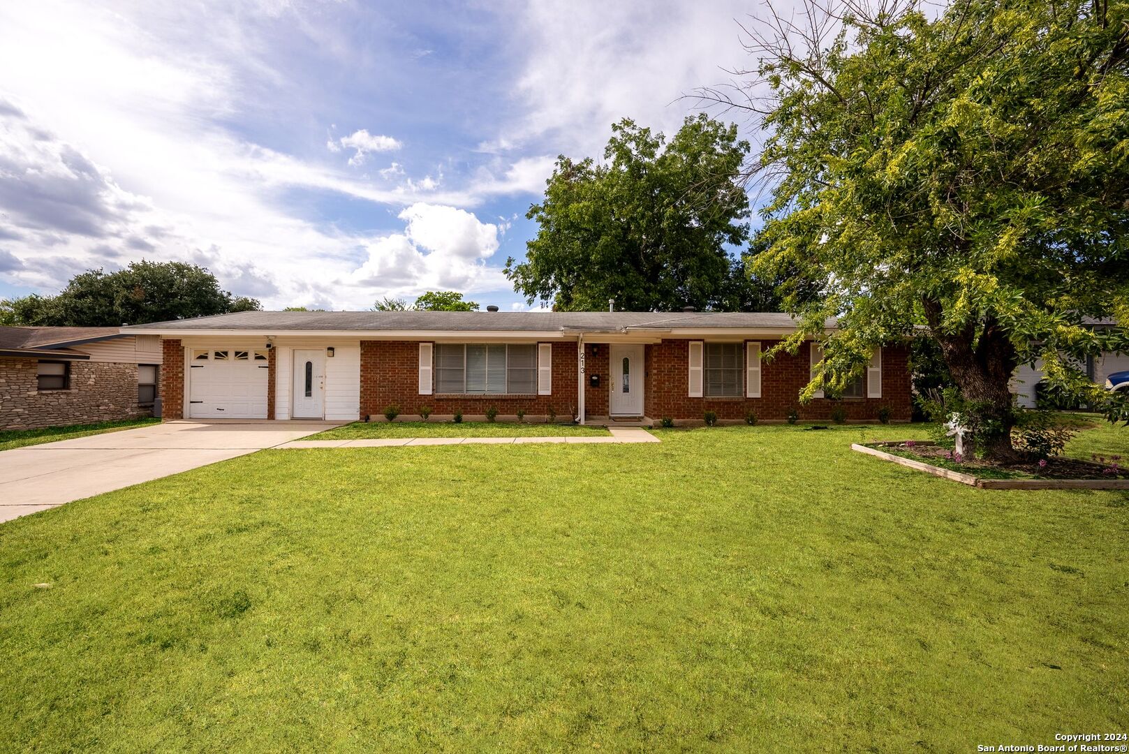 a front view of house with yard and green space