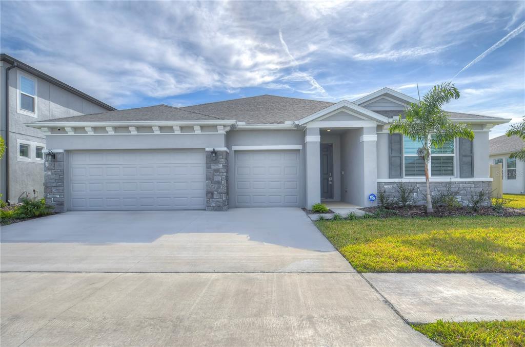 a view of a house with a yard and garage