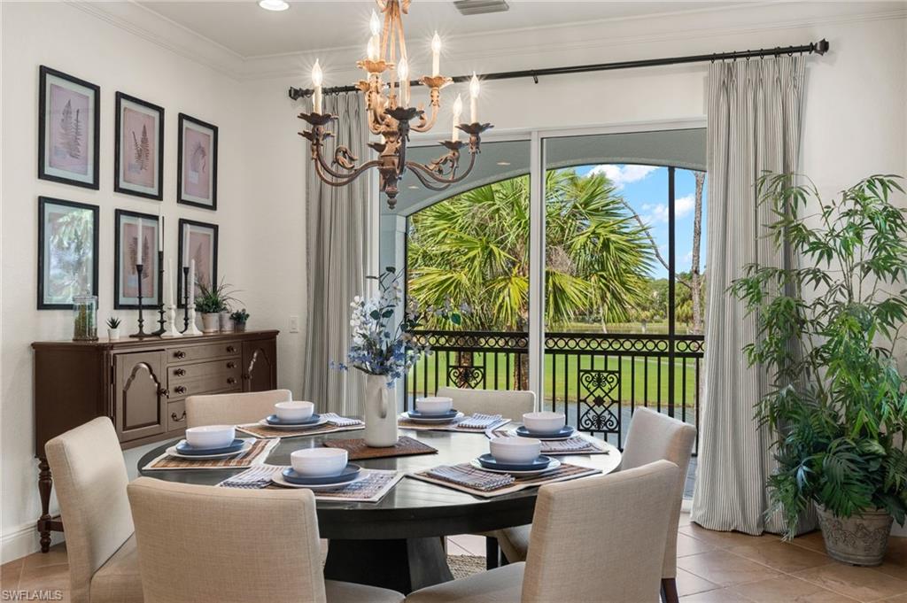 a dining room with furniture a chandelier and window