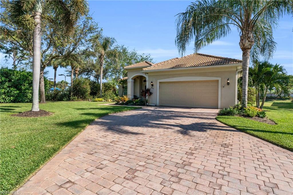 Mediterranean / spanish home with an oversized front yard and a two car garage