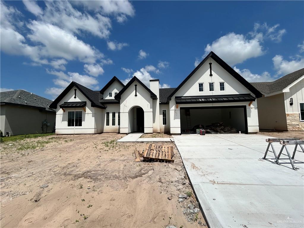 View of front of house with central AC and a front yard