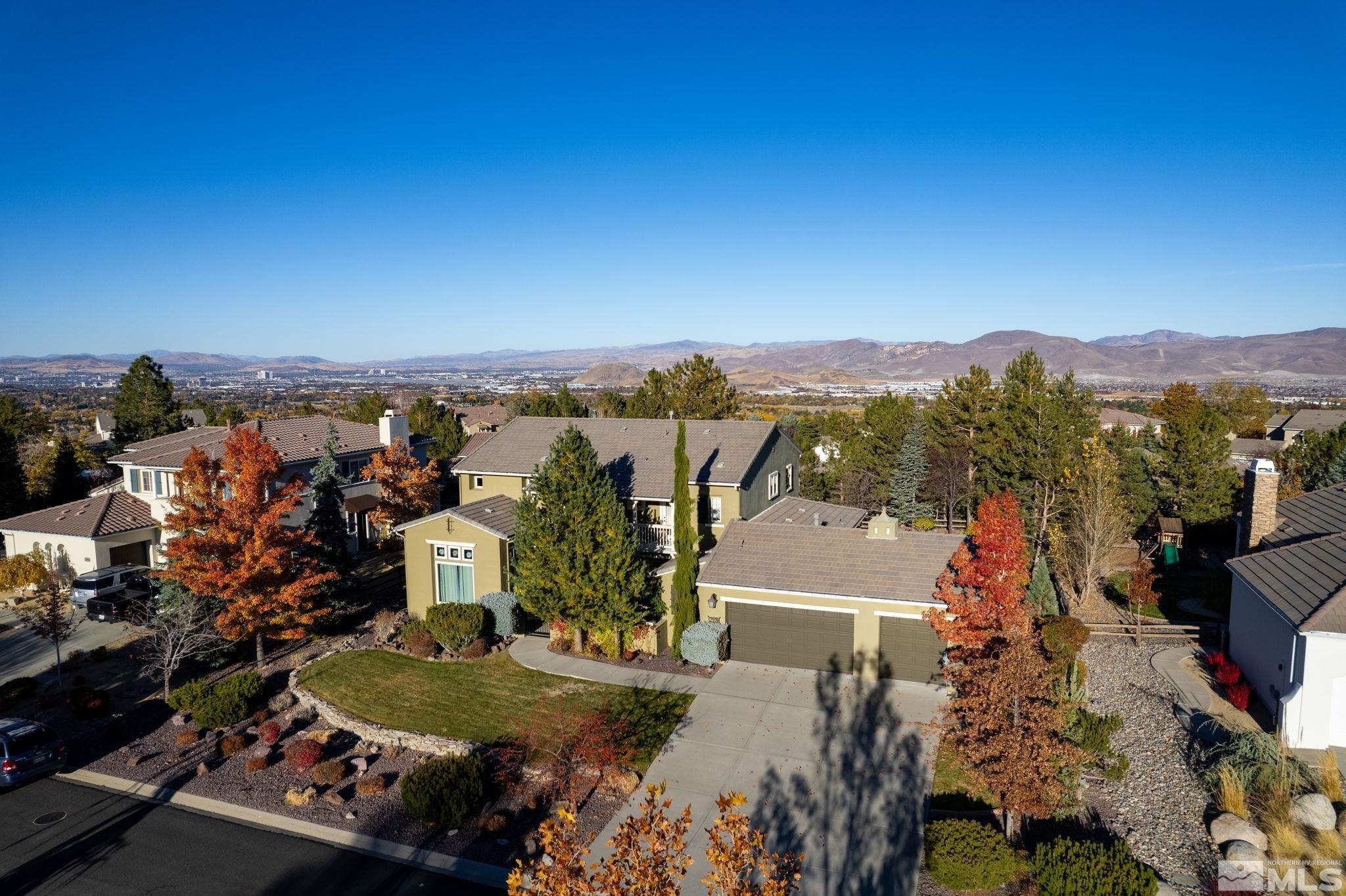 an aerial view of a house with a yard and lake view