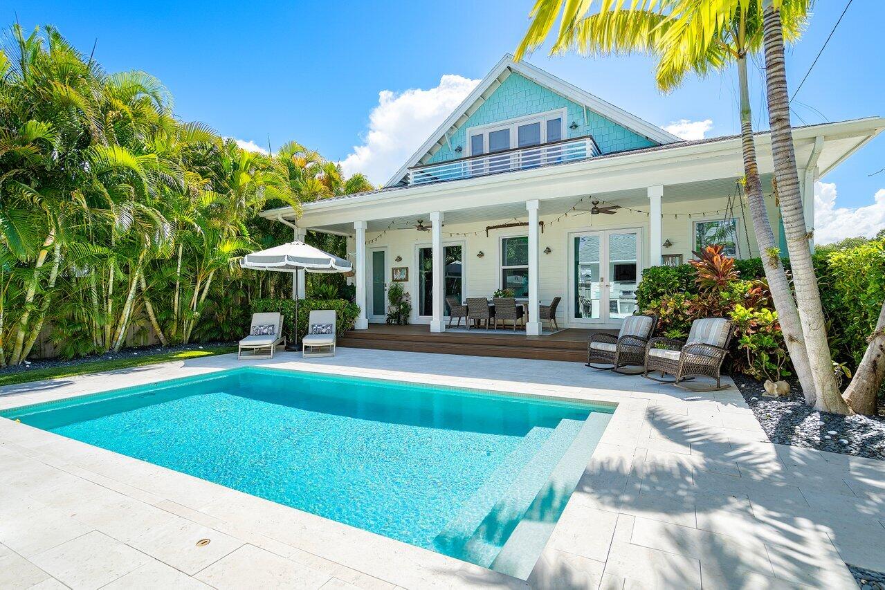 a view of a house with sitting area and a yard